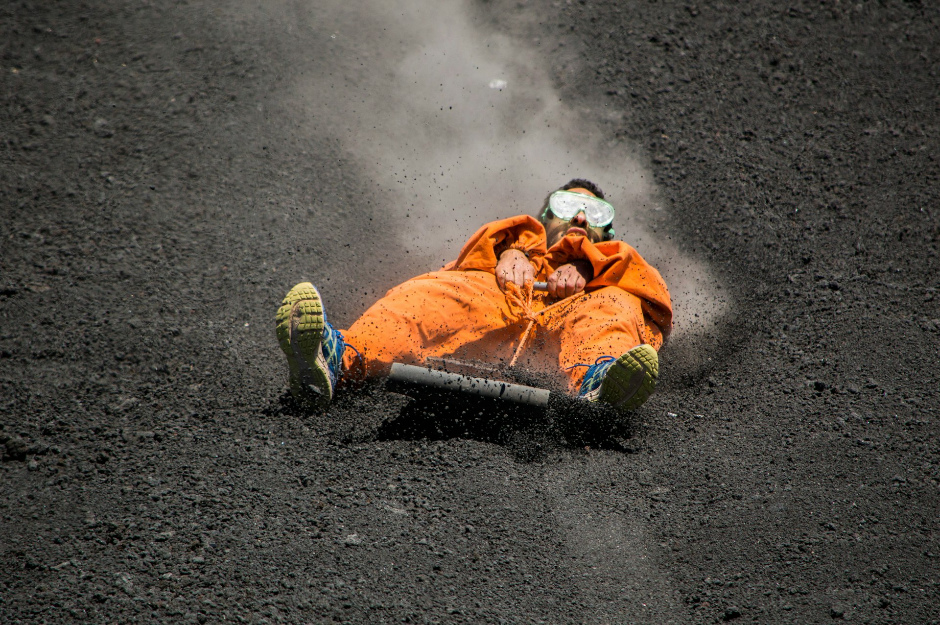 A guy is doing volcano boarding in the Cerro Negro of Nicaragua