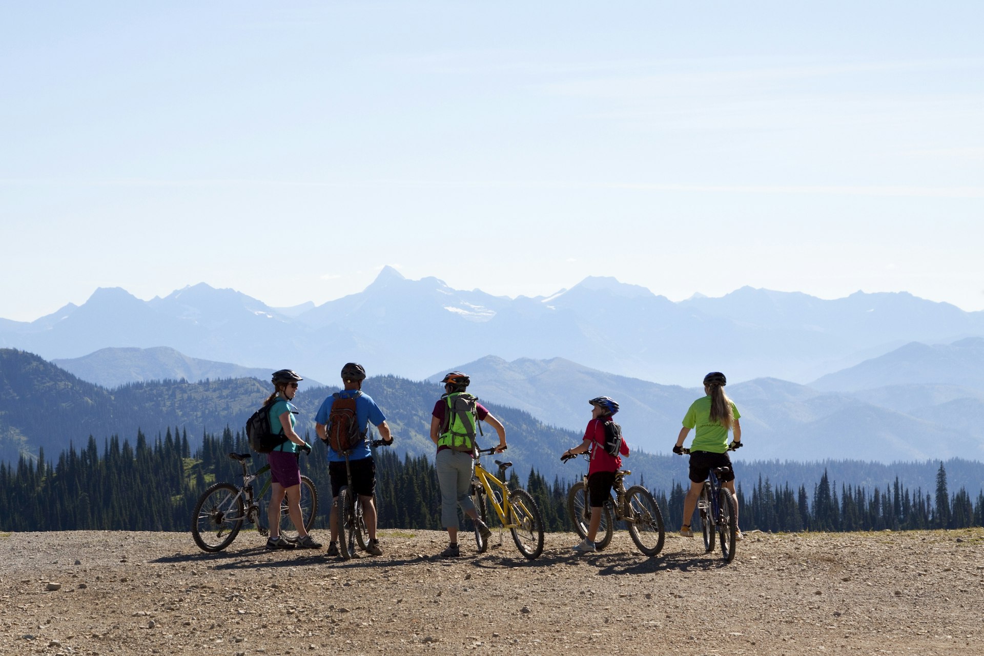 A family stand with bikes in Whitefish, Montana during summer.