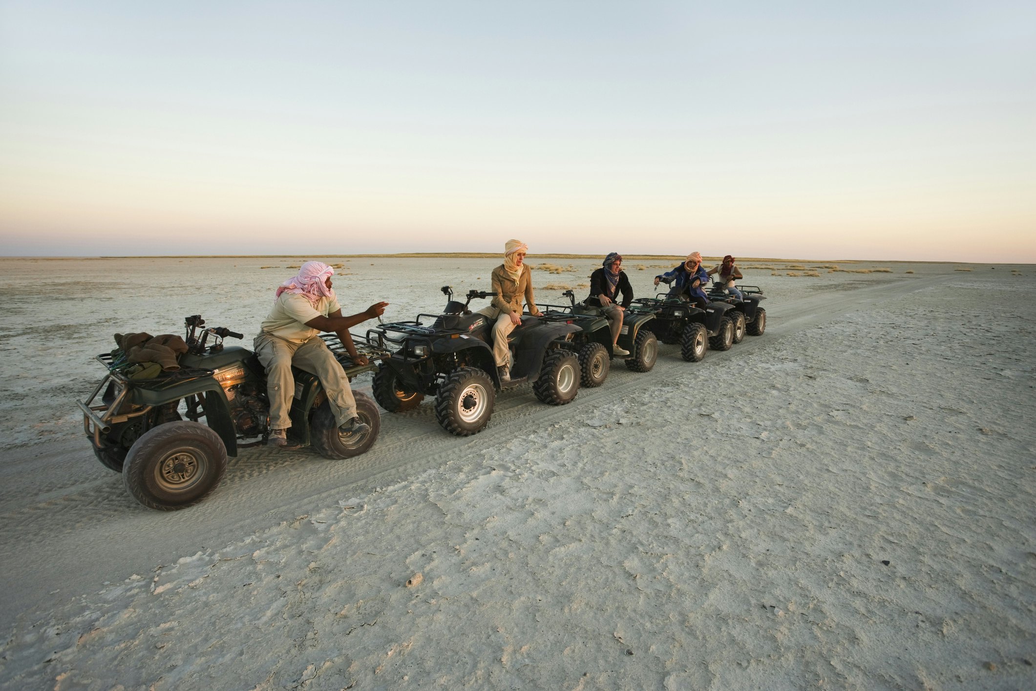 Tourists explore the salt flats of Makgadikgadi Pans on quad bikes, which are permitted on the fragile plains in single file only.