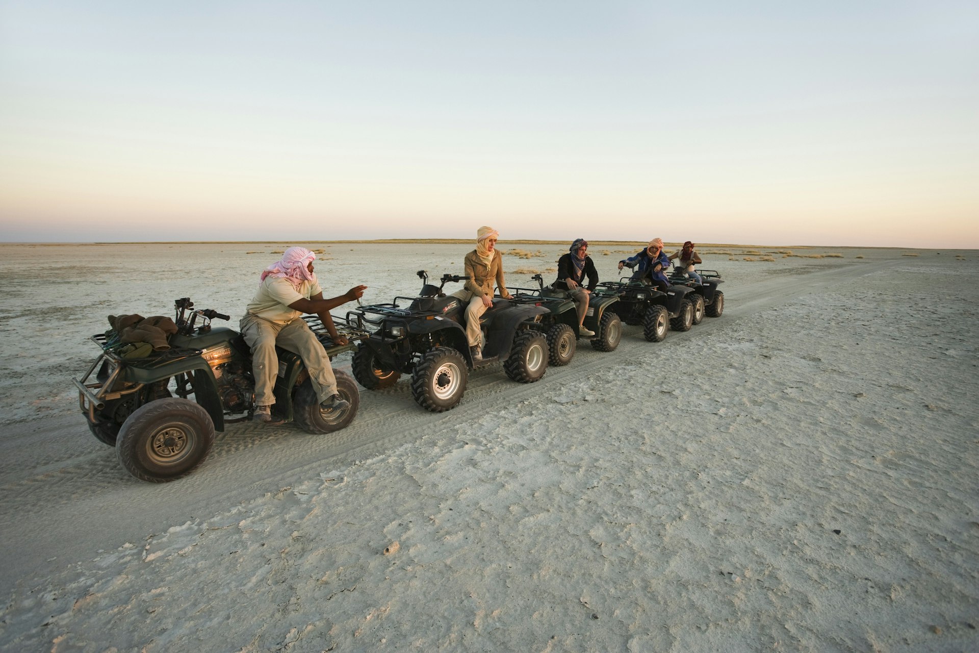 Tourists explore Botswana's salt flats on quad bikes