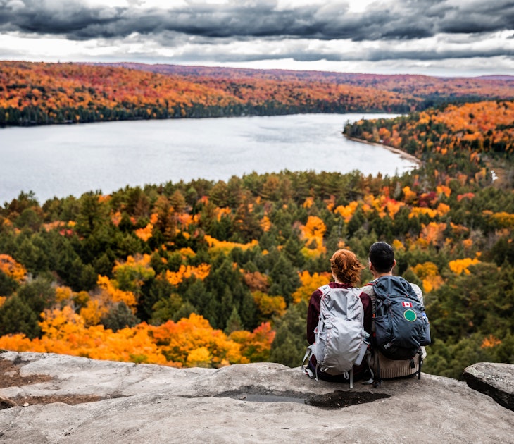 Young couple hiking in mountain and relaxing looking at view in the Algonquin Park, Ontario - Canada.
621242410
Couple - Relationship, Real People, Travel, Tourism, Outdoor Pursuit, Non-Urban Scene, Looking At View, Young Women, Women, Females, Young Men, Men, Males, Two People, Weekend Activities, Beauty In Nature, Algonquin Provincial Park, Young Adult, Adult, Backpack, Sitting, Scenics, Caucasian Ethnicity, Togetherness, Happiness, Romance, Friendship, Adventure, Exploration, Tranquil Scene, Travel Destinations, Nature, Outdoors, Rear View, Mountain Climbing, Hiking, Recreational Pursuit, People, Ontario - Canada, Canada, Autumn, Season, Mountain Peak, Mountain, Woodland, National Park