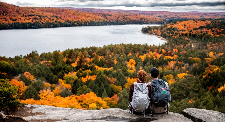 Young couple hiking in mountain and relaxing looking at view in the Algonquin Park, Ontario - Canada.
621242410
Couple - Relationship, Real People, Travel, Tourism, Outdoor Pursuit, Non-Urban Scene, Looking At View, Young Women, Women, Females, Young Men, Men, Males, Two People, Weekend Activities, Beauty In Nature, Algonquin Provincial Park, Young Adult, Adult, Backpack, Sitting, Scenics, Caucasian Ethnicity, Togetherness, Happiness, Romance, Friendship, Adventure, Exploration, Tranquil Scene, Travel Destinations, Nature, Outdoors, Rear View, Mountain Climbing, Hiking, Recreational Pursuit, People, Ontario - Canada, Canada, Autumn, Season, Mountain Peak, Mountain, Woodland, National Park