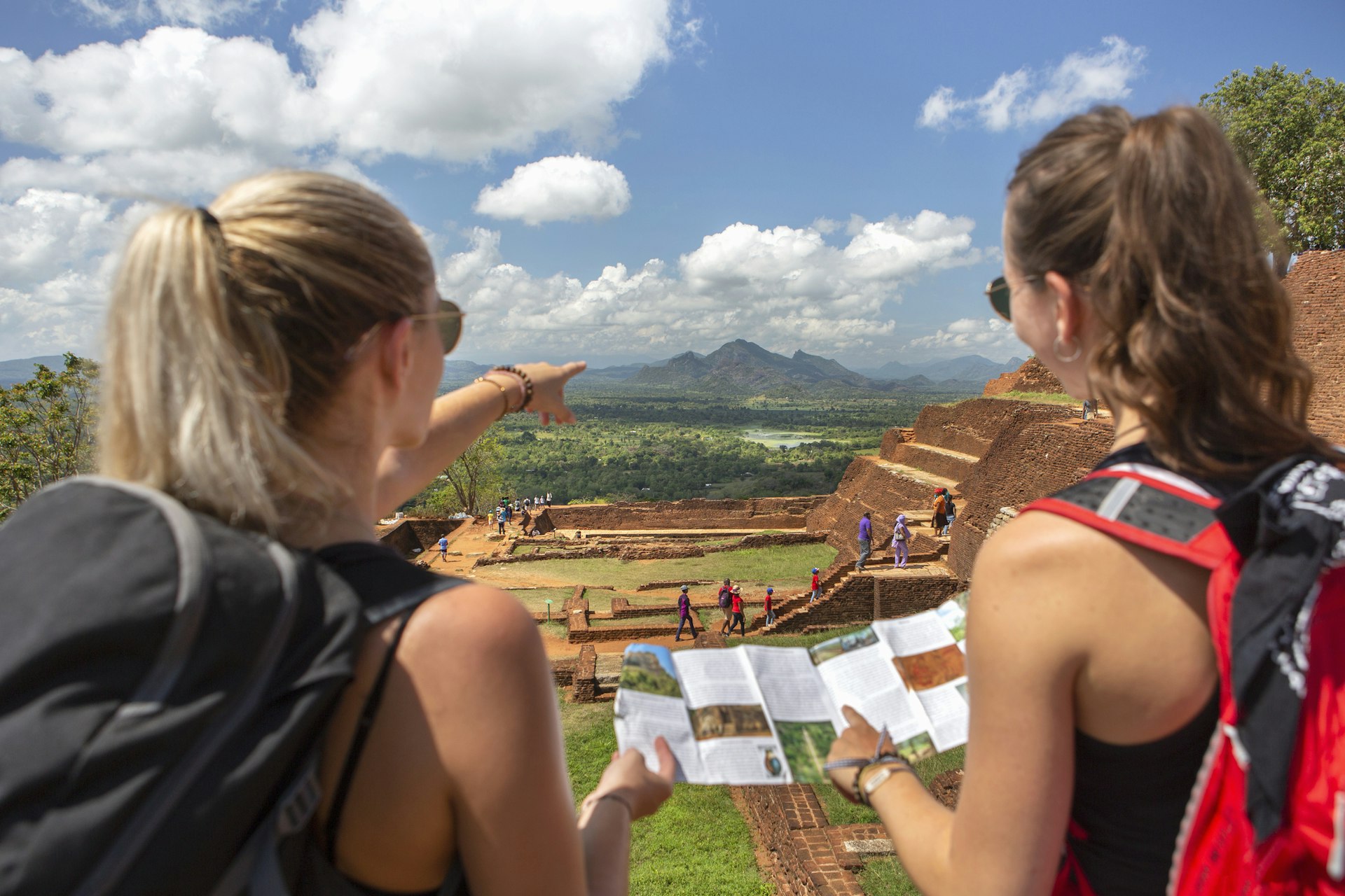 Two women hikers wearing backpacks on vacation at Sigiriya (Lion Rock) in central Sri Lanka