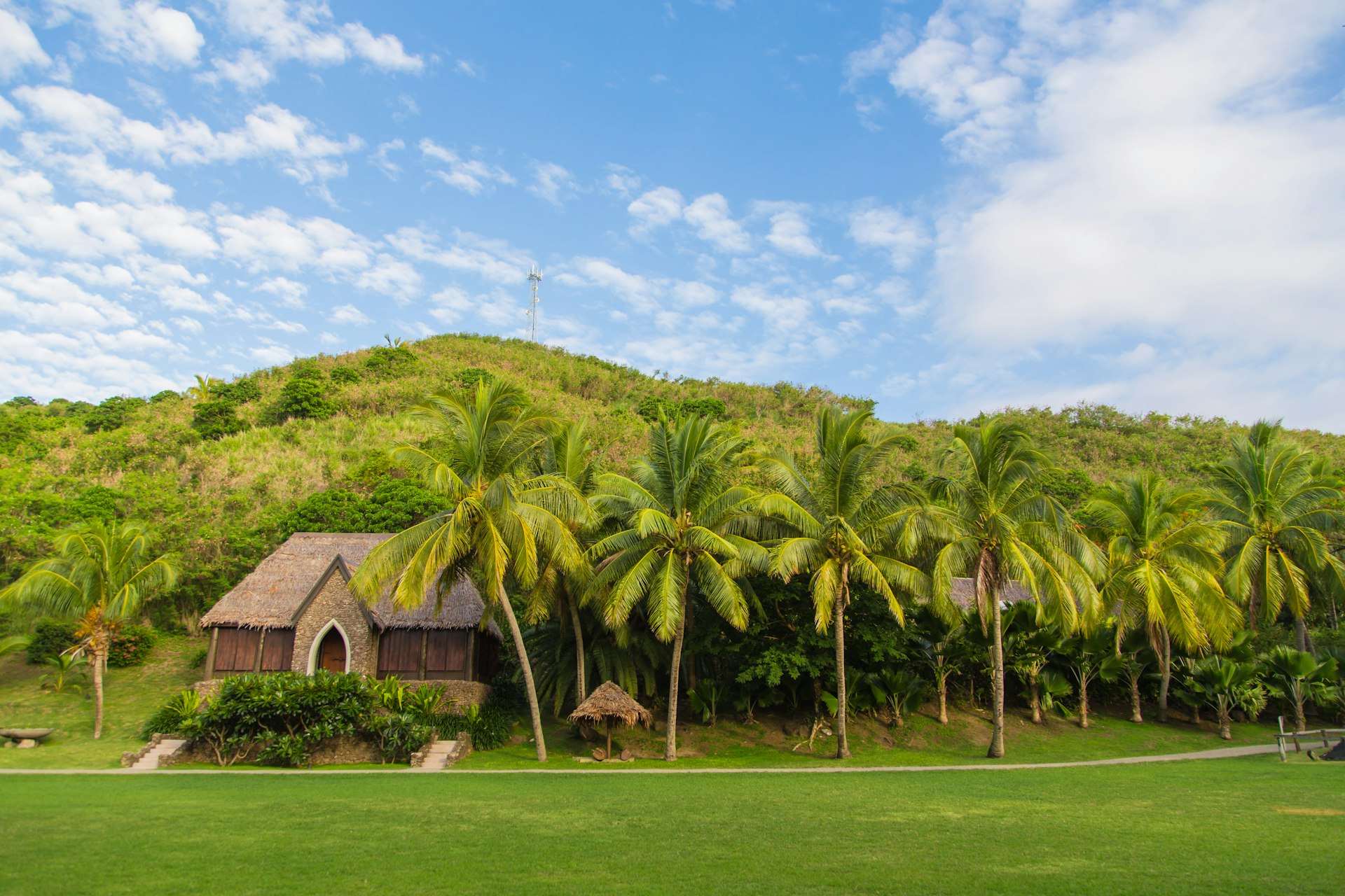 Local church in Fiji surrounded by lush green landscape