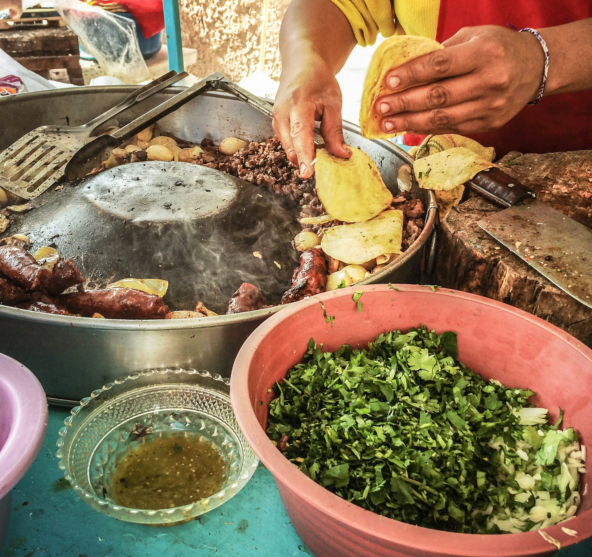 Hands of a Street vendor preparing food for Day of the Dead celebrations, Mexico