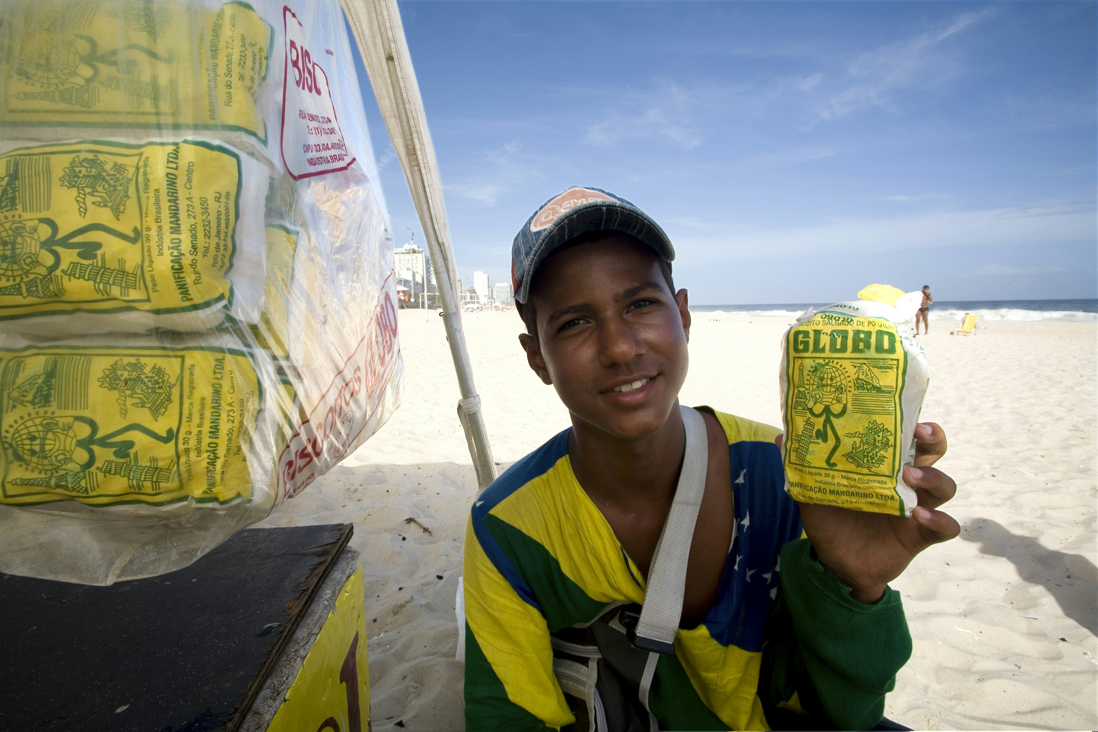 Portrait of young vendor selling Globo biscuits on the beach.