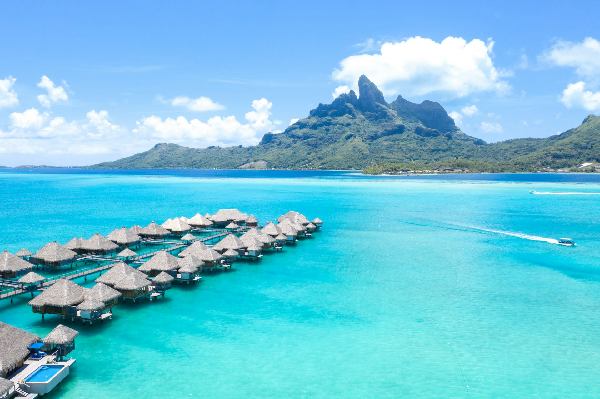 overheard view of overwater bungalows over turquoise water