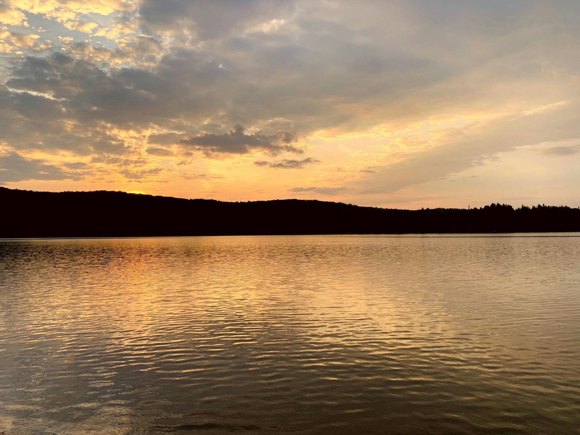 Glowing amber and pink sunset over Canisbay Lake