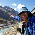 A pretty young lady enjoying the high altitude road trip along with the Chandra River in Ladakh in India.