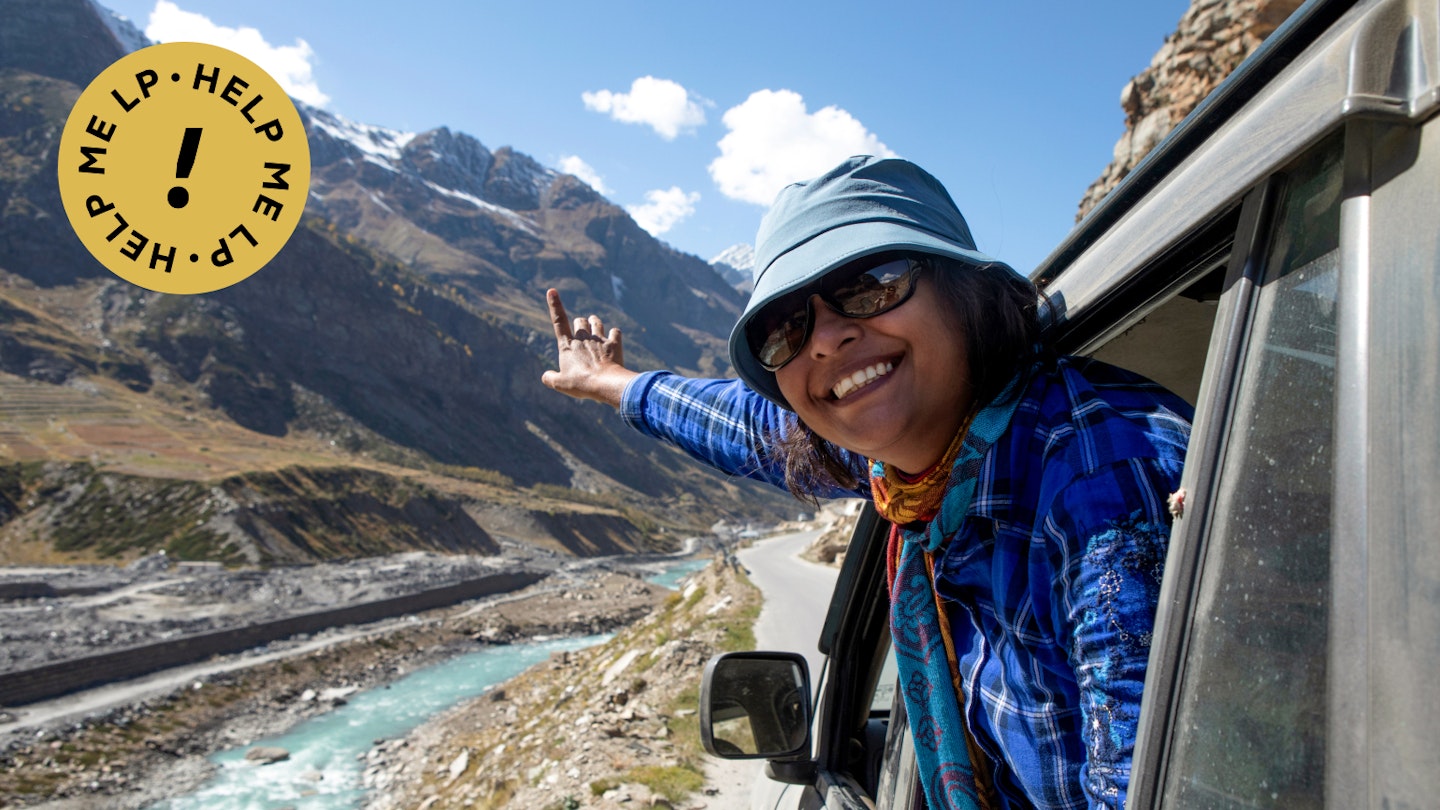 A pretty young lady enjoying the high altitude road trip along with the Chandra River in Ladakh in India.