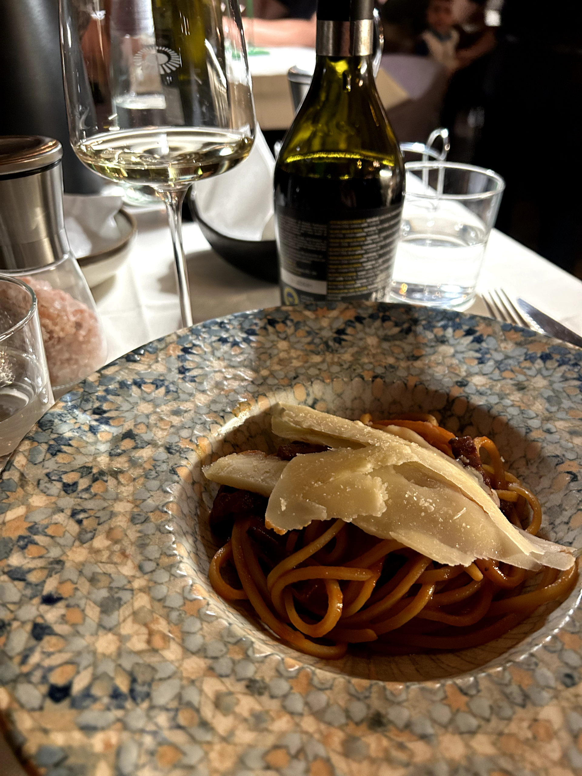 Spaghetti and white wine on a table at the family-run Hostaria Il Desco restaurant in Florence 