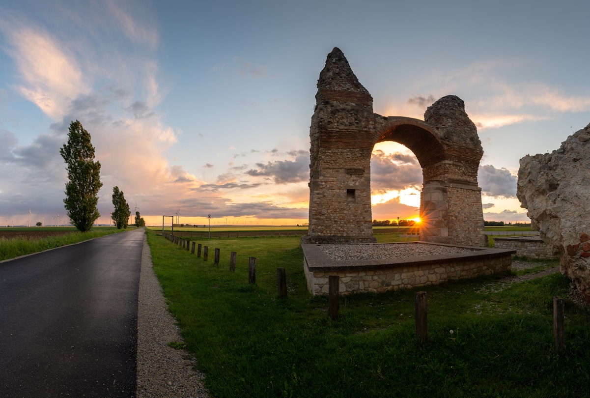 Panorama of the ruins of the triumphal arch Heathens' Gate in Carnuntum during sunset; Shutterstock ID 2143276995; full: 65050; gl: Lonely Planet Online Editorial; netsuite: BiT 2023: Danube Limes; your: Brian Healy
2143276995
agriculture, ancient, arch, architecture, austria, blooming, building, carnuntum, danube limes, europe, field, heathens gate, heidentor, historic, horizontal, landmark, landscape, lower austria, monument, old, petronell, rape field, roman, roman empire, ruin, rural, tourist attraction, travel destination, triumphal arch, wind turbines