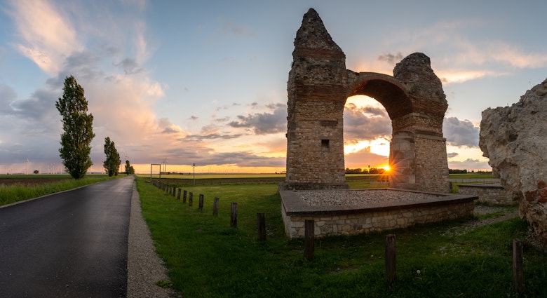 Panorama of the ruins of the triumphal arch Heathens' Gate in Carnuntum during sunset; Shutterstock ID 2143276995; full: 65050; gl: Lonely Planet Online Editorial; netsuite: BiT 2023: Danube Limes; your: Brian Healy
2143276995
agriculture, ancient, arch, architecture, austria, blooming, building, carnuntum, danube limes, europe, field, heathens gate, heidentor, historic, horizontal, landmark, landscape, lower austria, monument, old, petronell, rape field, roman, roman empire, ruin, rural, tourist attraction, travel destination, triumphal arch, wind turbines