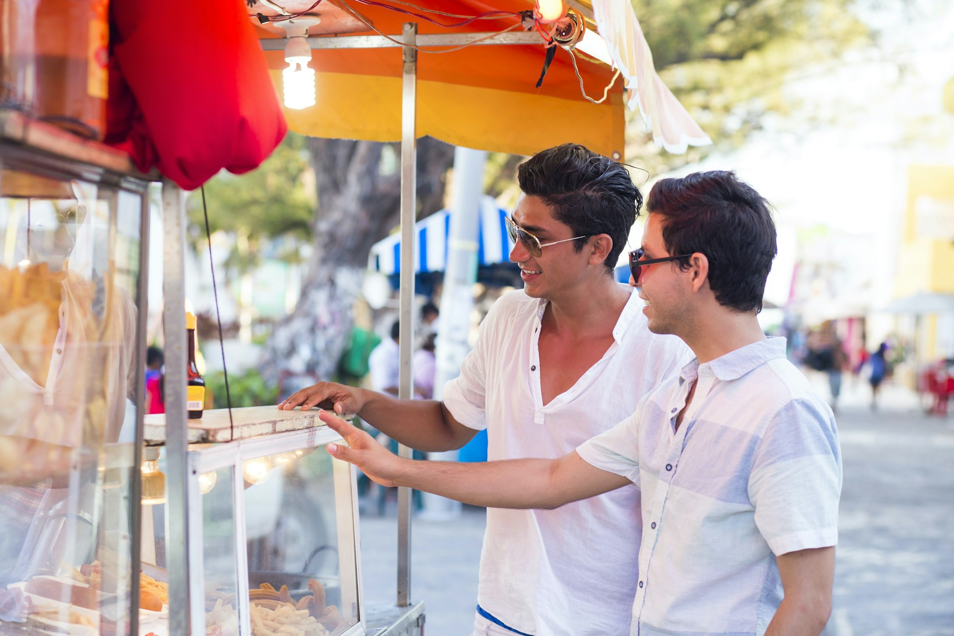 Two men purchasing food at a food truck in Mexico