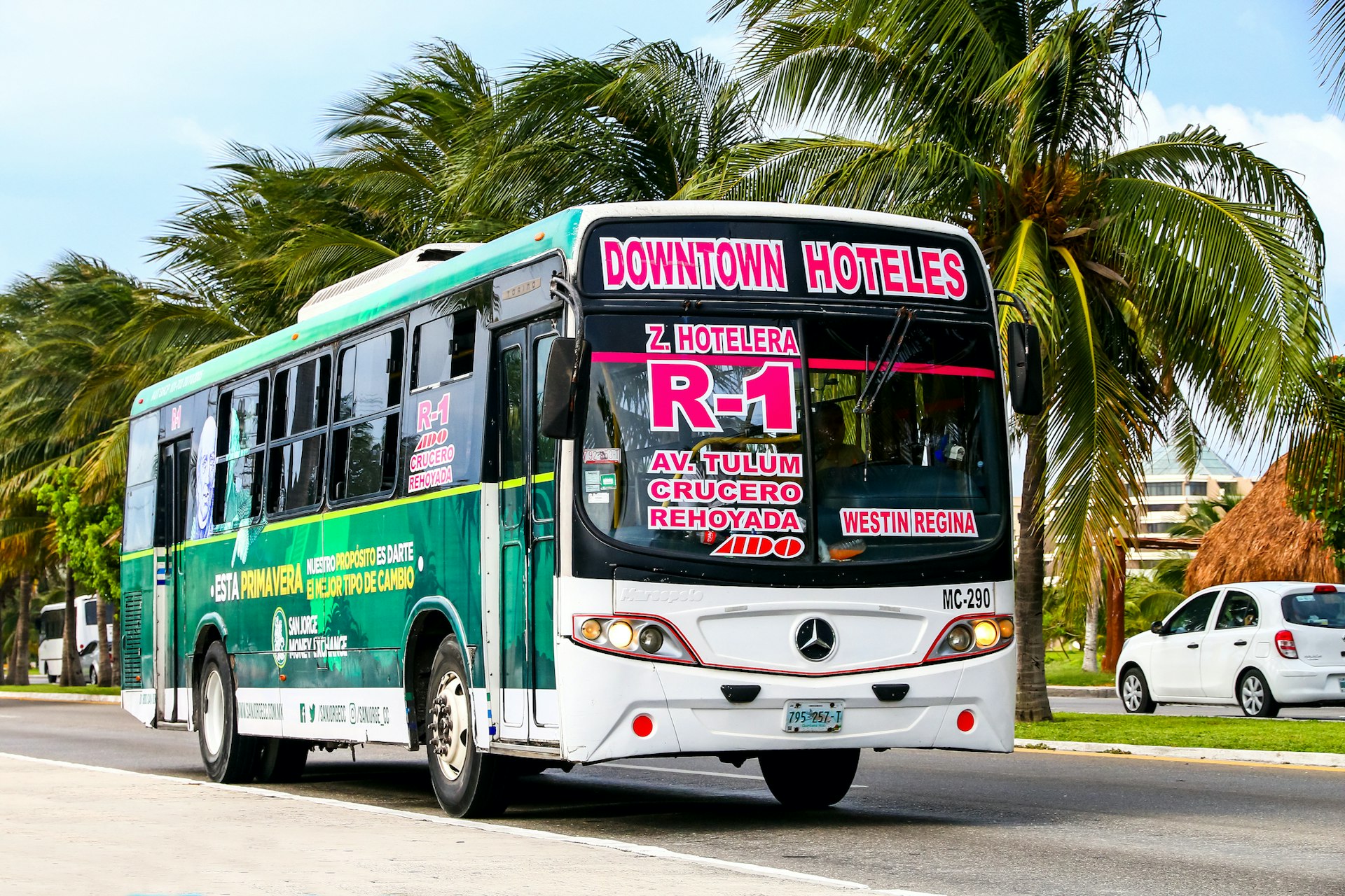 A local bus driving along the street in Cancún, Mexico