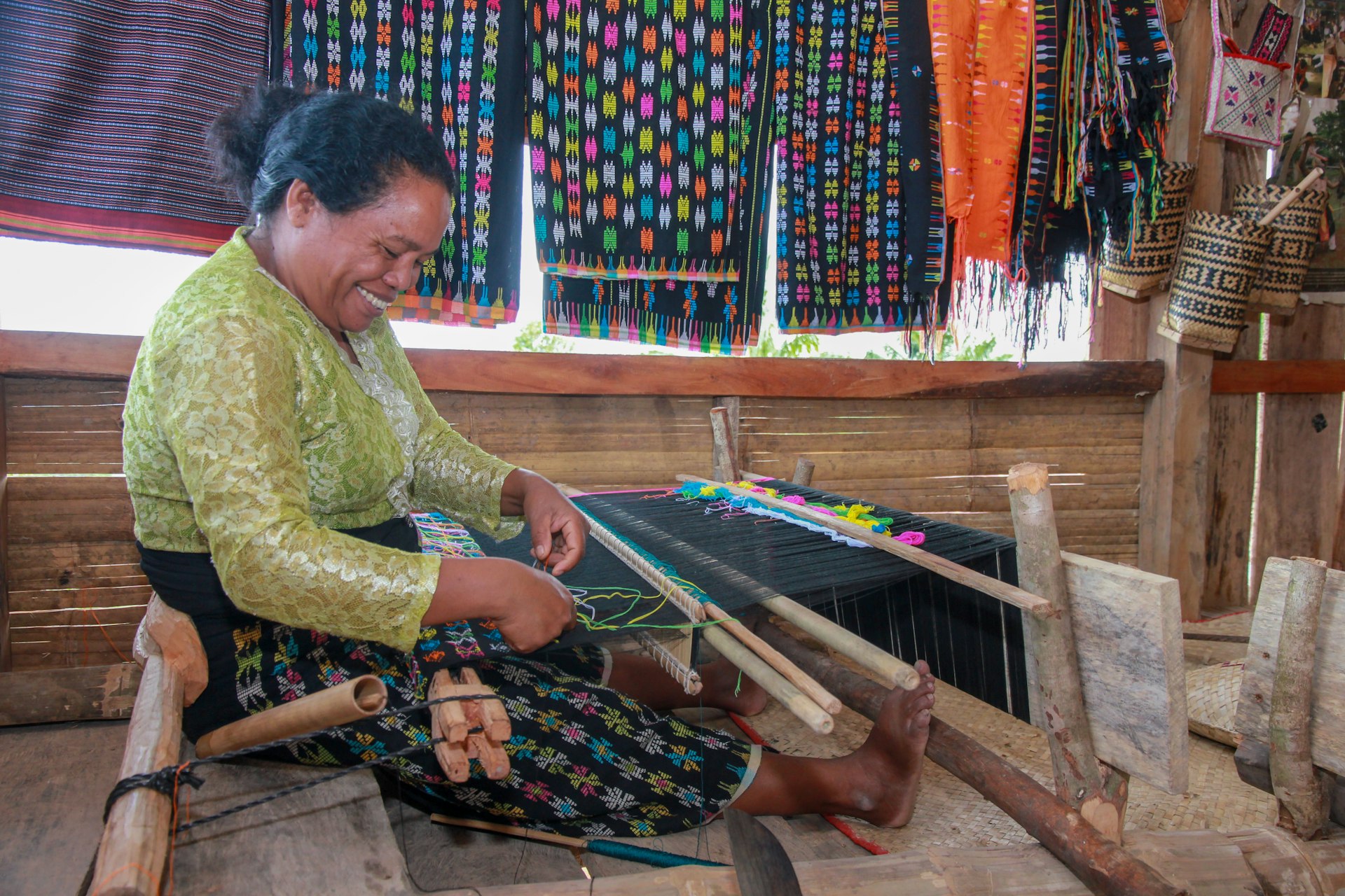 A woman weaving traditional handmade fabric on Flores Island.