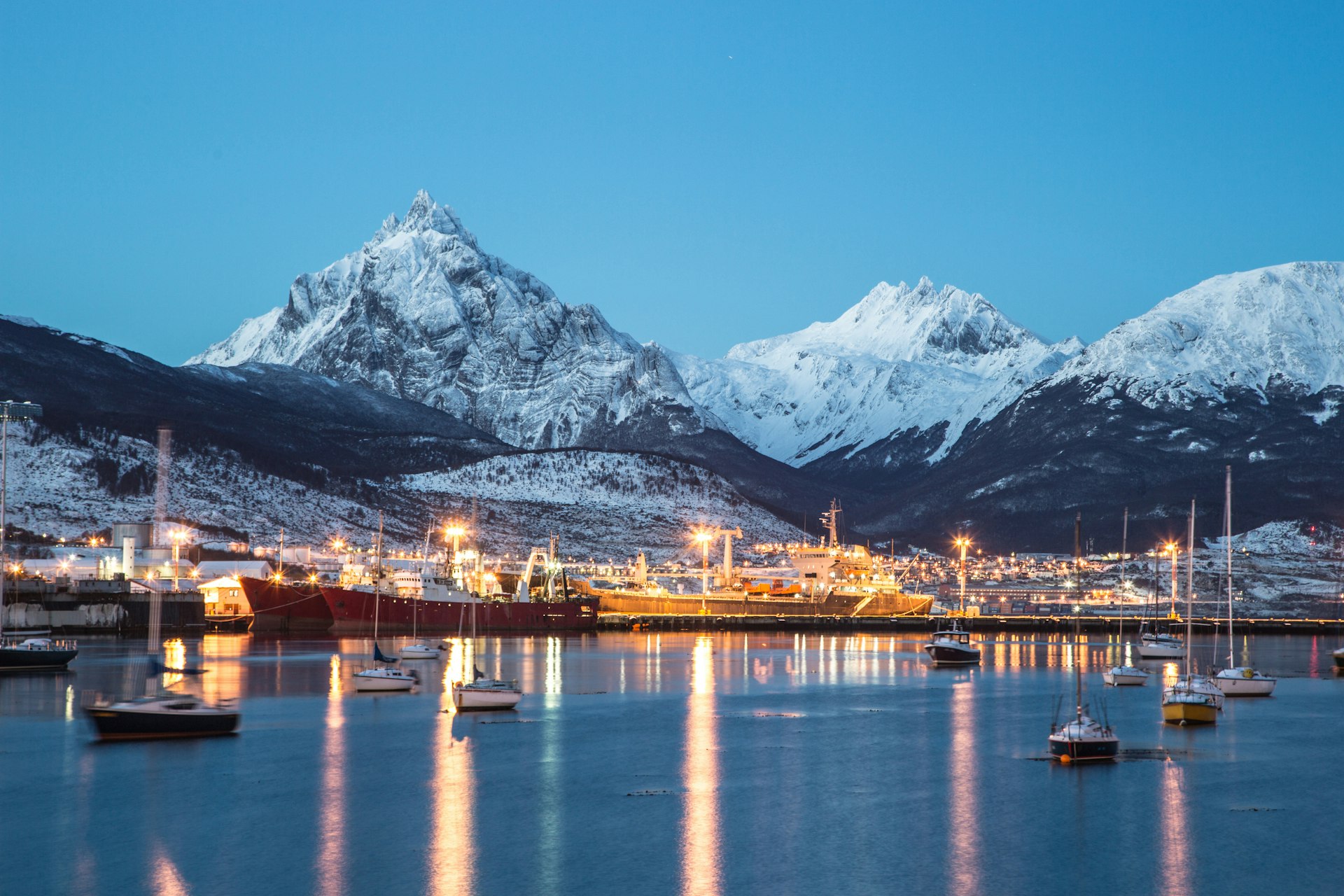 The port of Ushuaia at night surrounded by snow-capped mountains, Ushuaia, Patagonia, Argentina, South America