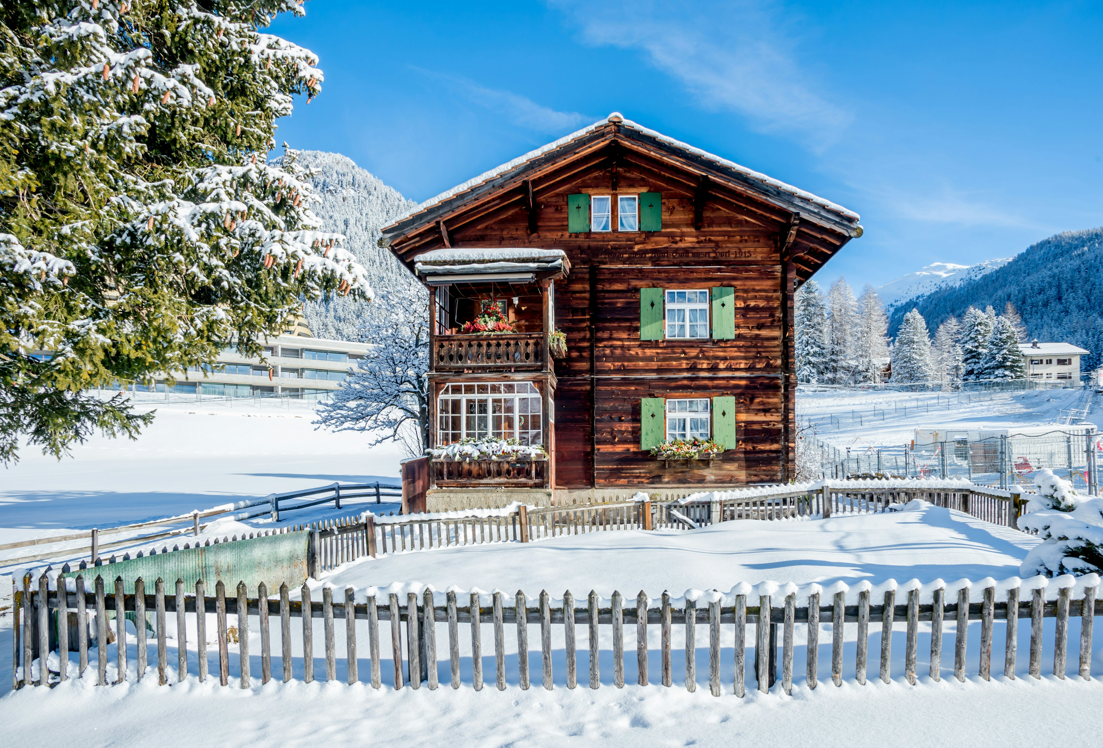 Old wood chalet in Davos, Switzerland on sunny winter day.