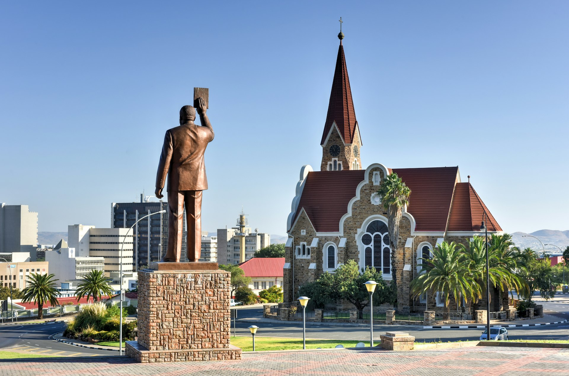A city with a church and a large statue