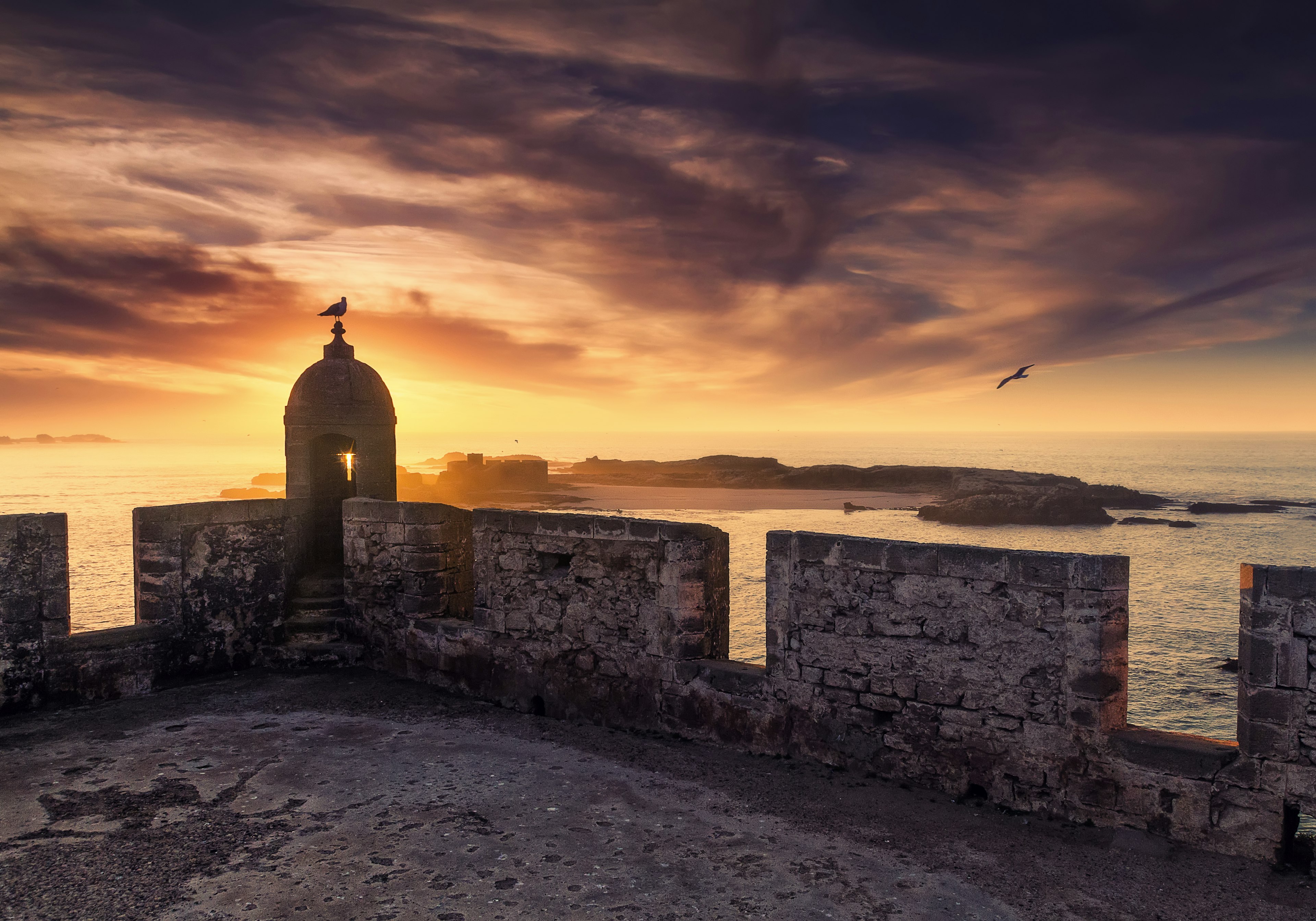 A coastal fortress at sunset