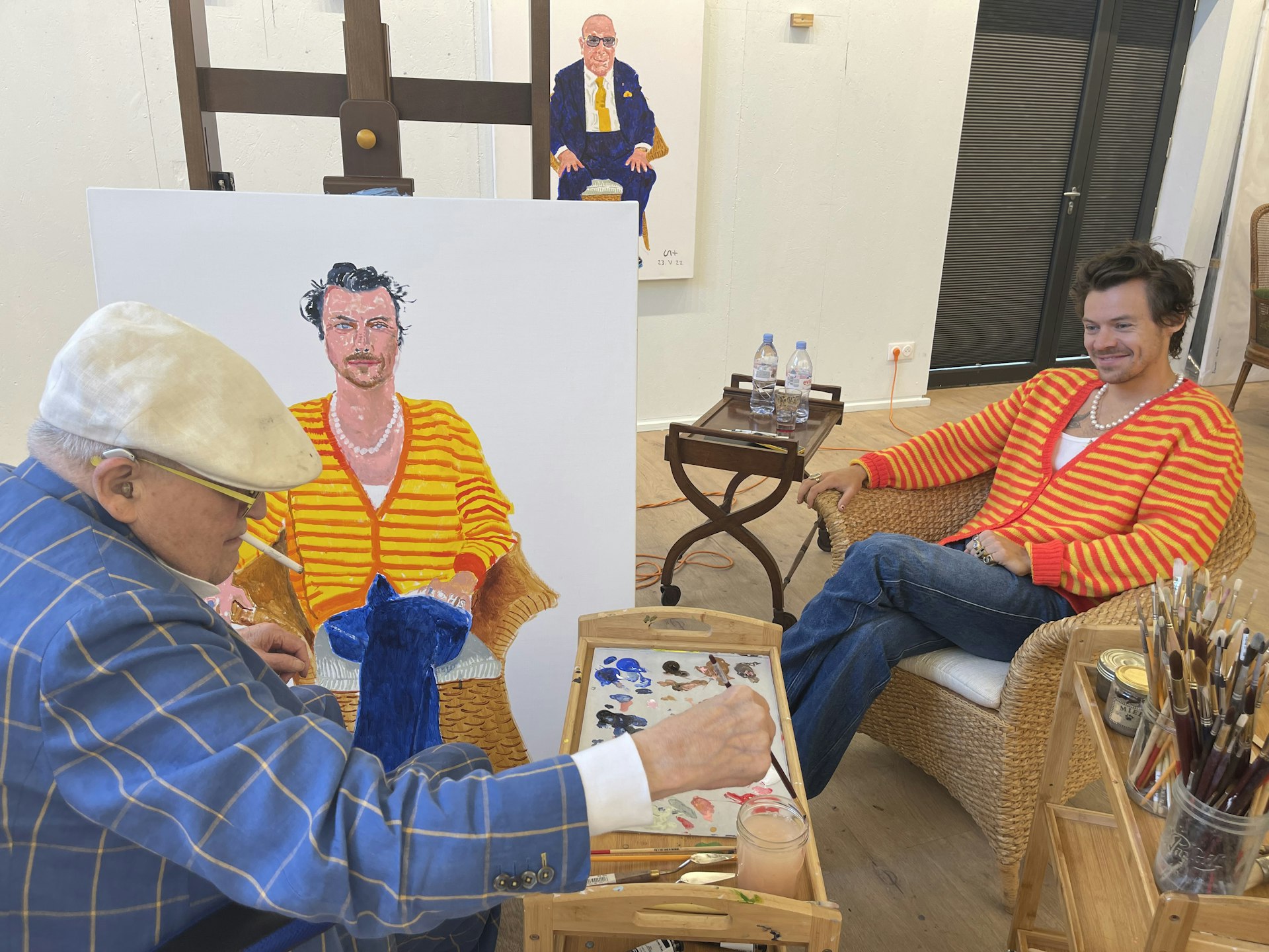 David Hockney painting Harry Styles (with "Portrait of Clive Davis" in background) at Normandy Studio, London, UK