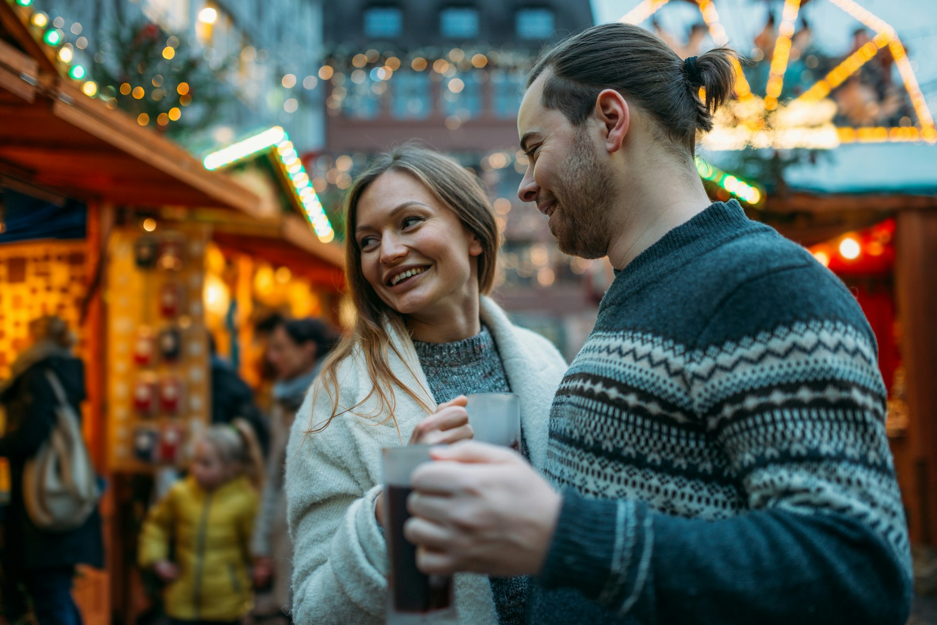 Mixed millennial couple enjoying Christmastime at a Christmas market in Germany