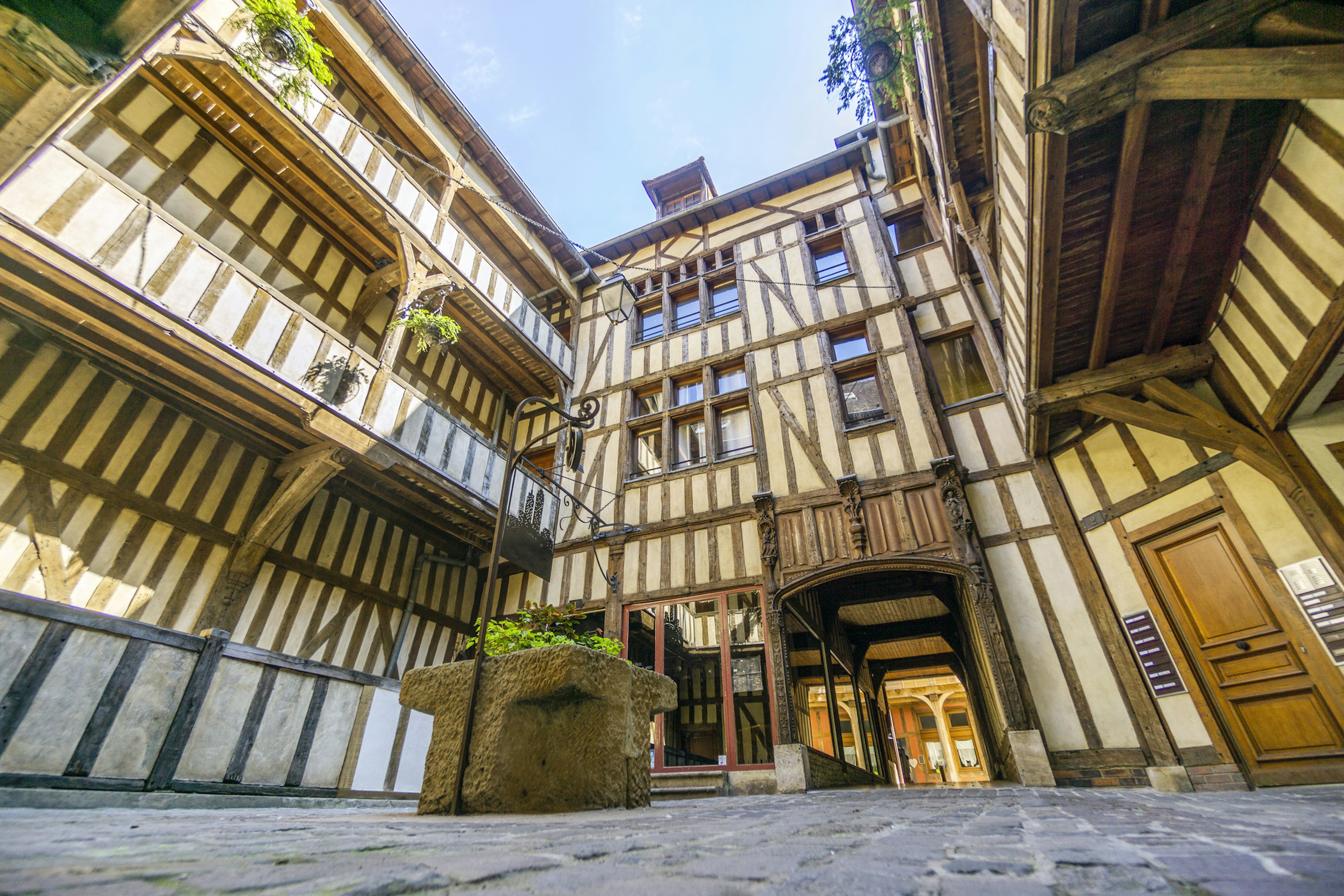 A medieval courtyard surrounded by half-timbered houses