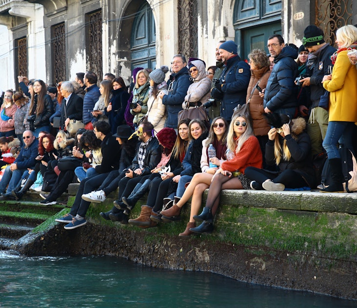 People watch the the traditional regatta for the opening of the 2019 Venice Carnival on February 17, 2019 in Venice, Italy. The theme for the 2019 edition of Venice Carnival is 'Blame the Moon!' and will run from the 16th of February to 5th of March 2019  (Photo by Matteo Chinellato/NurPhoto via Getty Images)
1125751716
Venica Carnival, Venice, Opening Event, Italian Culture, Italy, Arts Culture and Entertainment, Venice - Italy, February 17, 2019, 17th February 2019, People, Parade, Traditional Parade, Blame of The Moon, Parade Vencie Carnival Venice, Mask, Masked People, Traditional, Crowd, Waterway, Water, Team, Fun, Tourism, Event, Recreation, Leisure, Vehicle, person, outdoor, people, group, edition of Venice Carnival, opening, Matteo Chinellato, NurPhoto, traditional regatta, theme, Moon, Human Interest, Venice