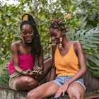 Young ladies hanging out under the tropical sunshine in Jamaica, Laughing, hairstyling each others hair smiling and happy...Photography by Nickii Kane for New wave JA.
1142811942