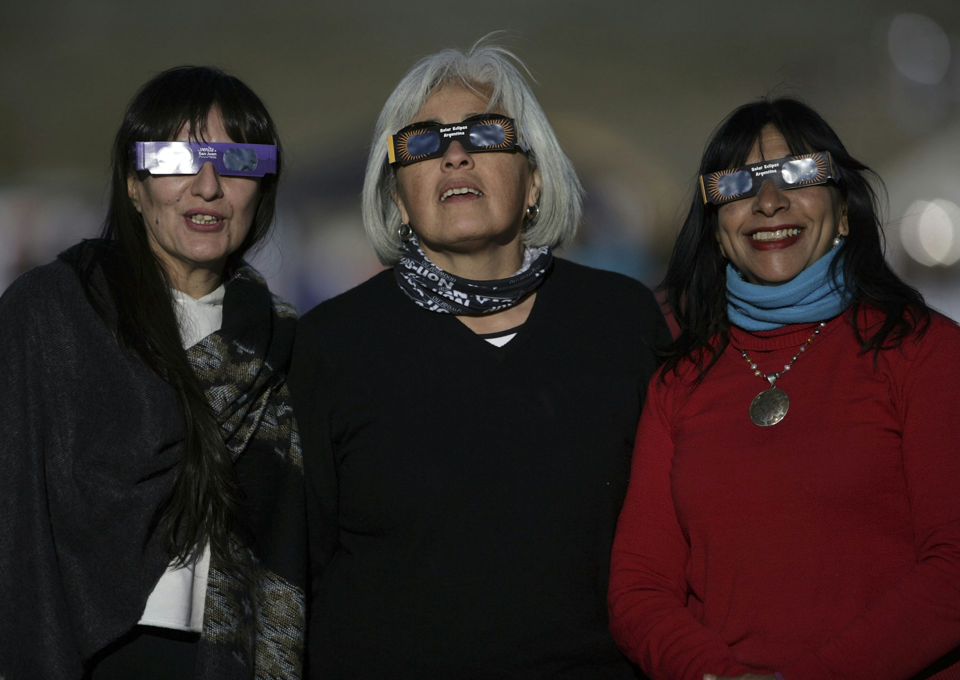 Women observe the total solar eclipse in the town of Bella Vista, San Juan, Argentina