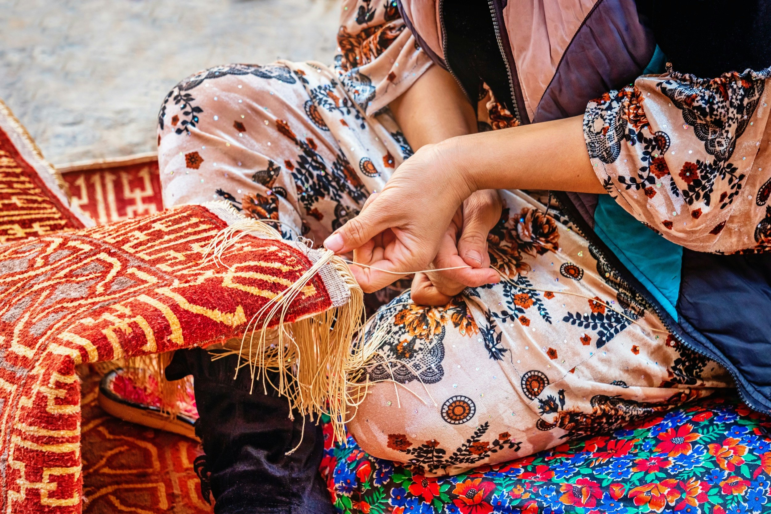 Detail of a female uzbek carpet weaver weaving a typical oriental uzbek silk carpet in Itchan Kala Old Town