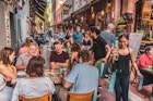 Melbourne, Victoria, Australia, January 25, 2020: Hardware Lane in Melbourne, Australia is a popular tourist area filled with cafes and restaurants featuring al fresco dining.
1206150505
People drinking and eating along Hardware Lane in Melbourne, Australia