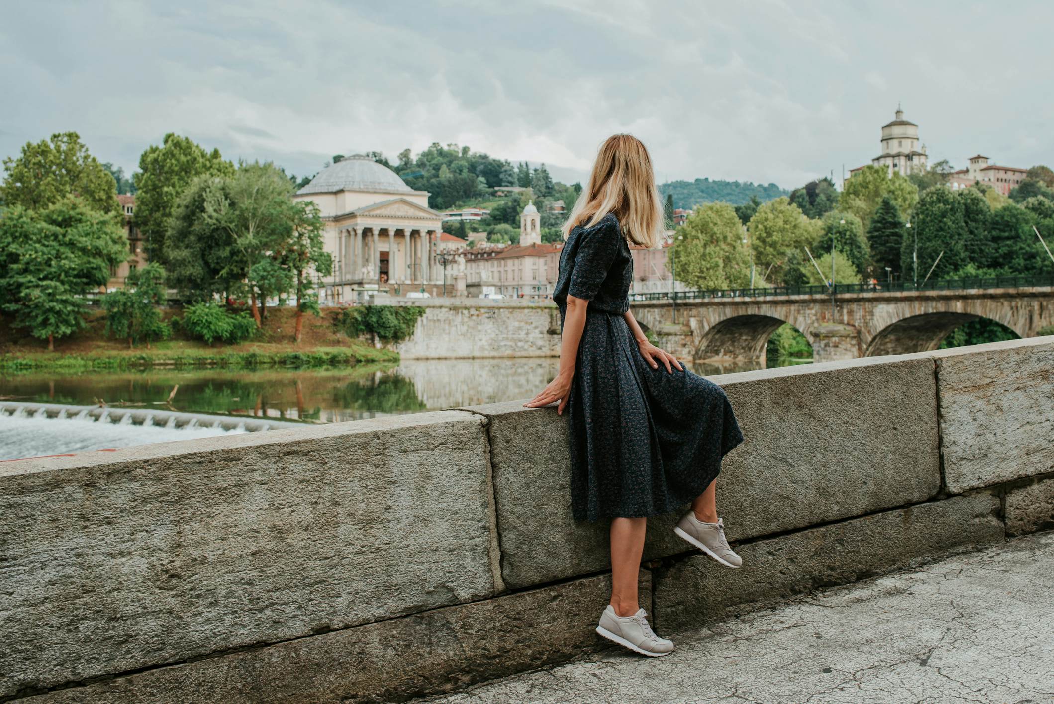 A beautiful woman with blond hair walks through the streets of the city. Girl enjoy holidays in Europe. Beautiful historical architecture. Italian weekend. Travel to Turin, Italy. Adventure lifestyle
1214448541