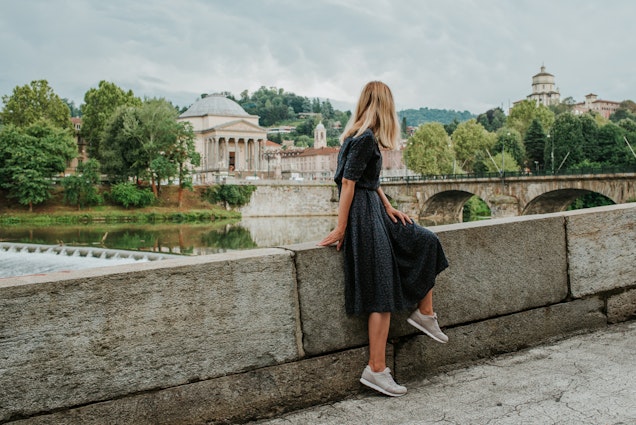 A beautiful woman with blond hair walks through the streets of the city. Girl enjoy holidays in Europe. Beautiful historical architecture. Italian weekend. Travel to Turin, Italy. Adventure lifestyle
1214448541
