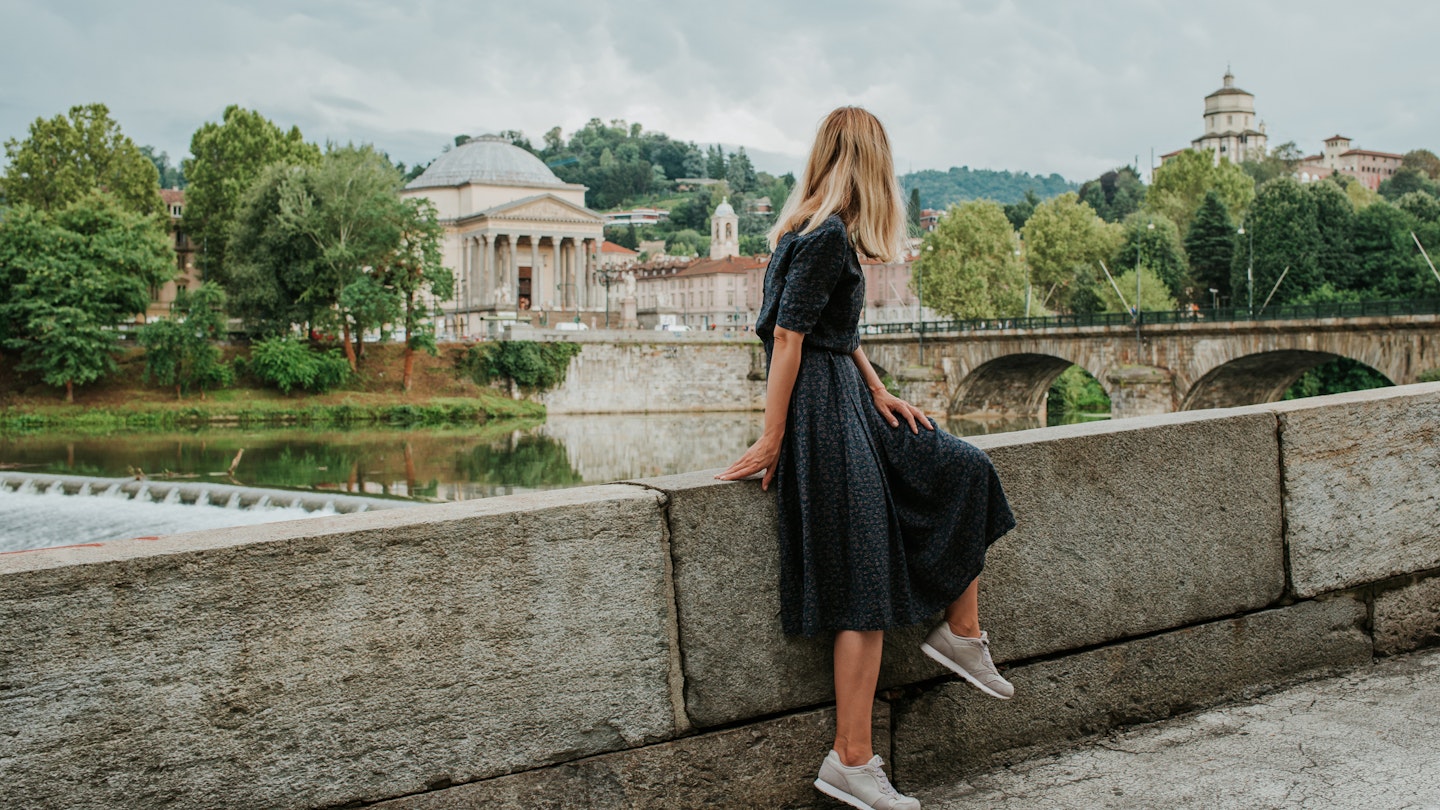 A beautiful woman with blond hair walks through the streets of the city. Girl enjoy holidays in Europe. Beautiful historical architecture. Italian weekend. Travel to Turin, Italy. Adventure lifestyle
1214448541