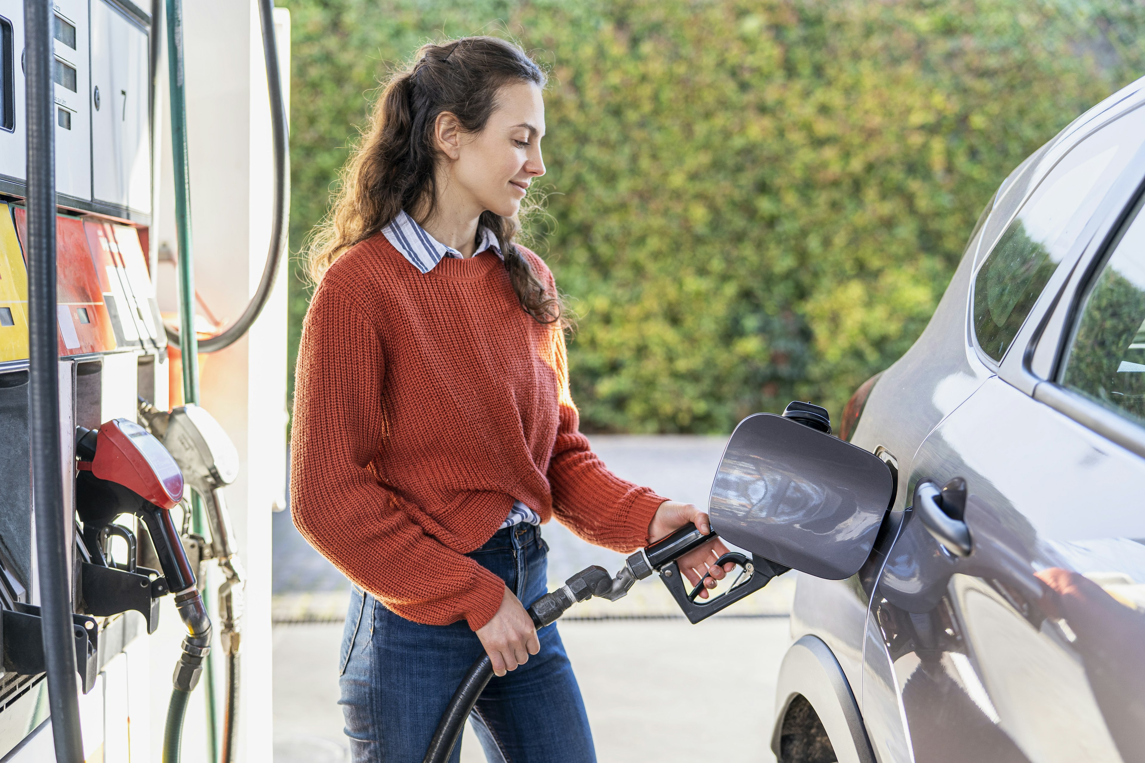 Pumping gas at a gas station