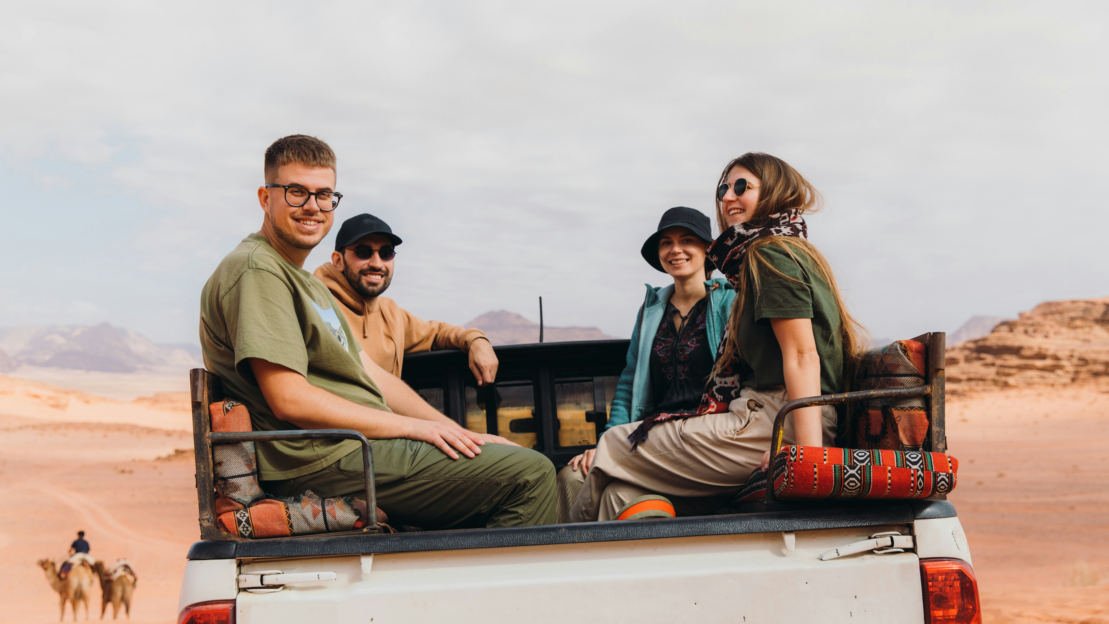 A group of friends sitting in the back of a 4x4 truck in Jordan