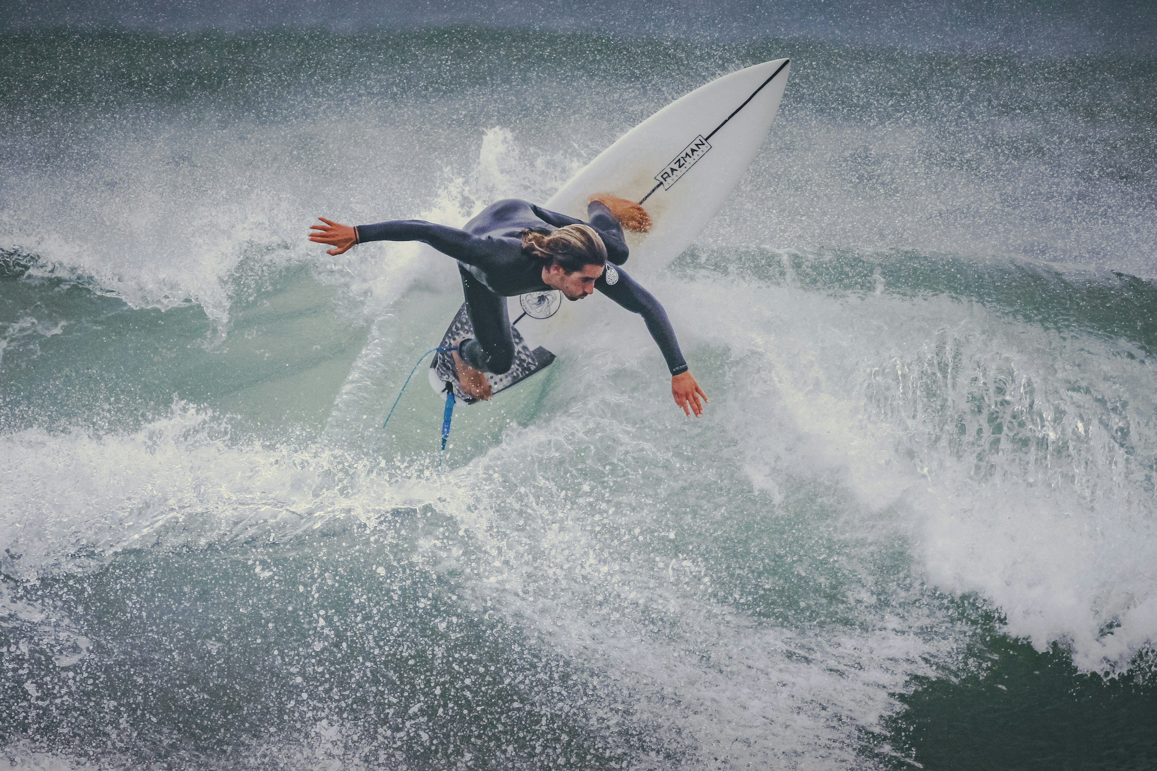 Surfer at practice in the waters of Peniche during winter months with rough water. Peniche has become one of the favorite spots for surfing in Portugal, with many different beaches with different levels of difficult