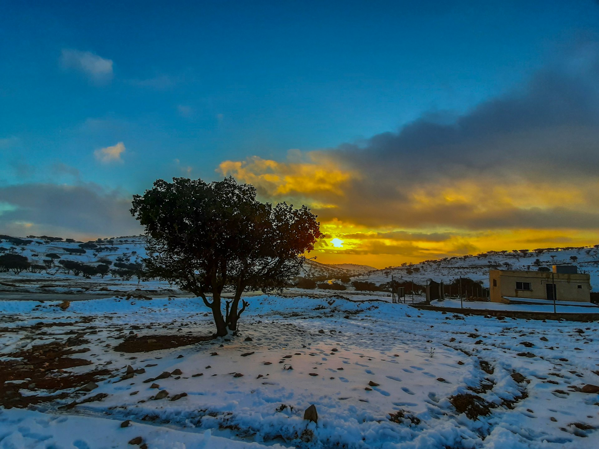 A beautiful sunset behind snowy hills in Jordan