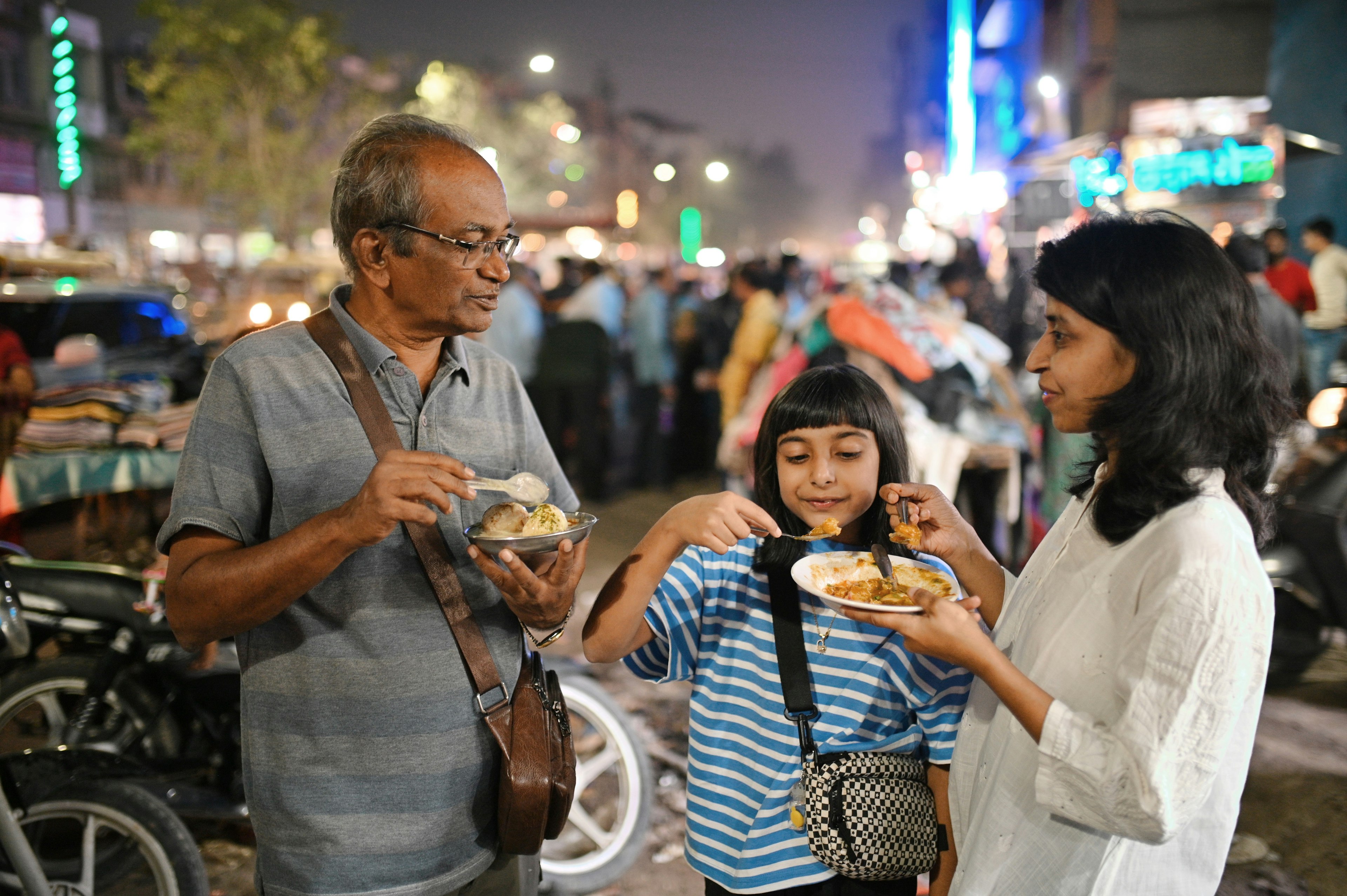 A multigenerational family enjoys food stalls in Jodhpur, Rajasthan, India