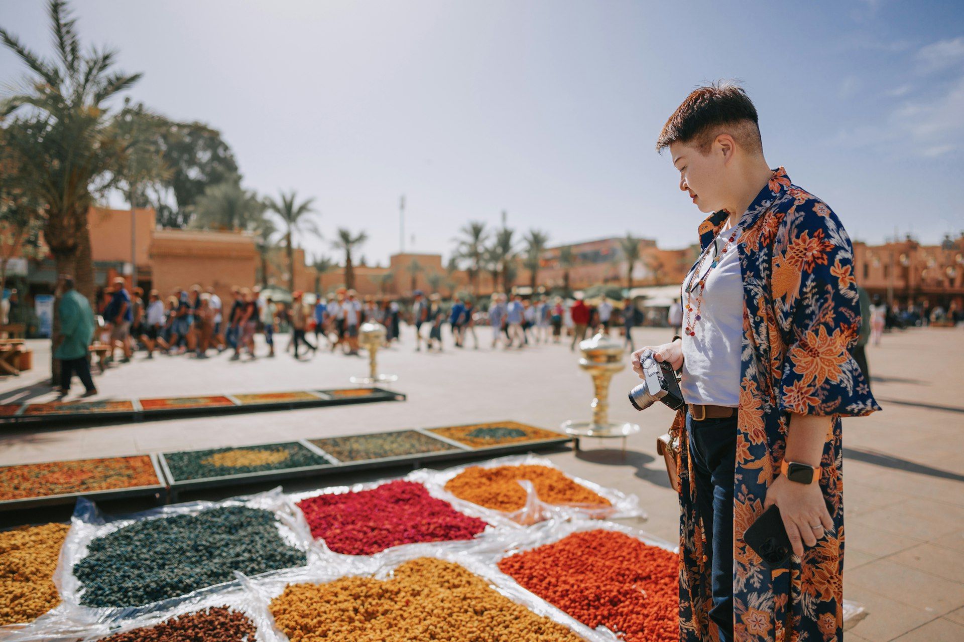 A traveler browses a stall selling dried flowers in Marrakesh, Morocco