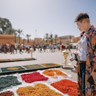 Curious Asian Chinese female tourist looking at colourful dried flowers on a market in a bazaar in Marrakech, Morocco, North Africa
1452433155