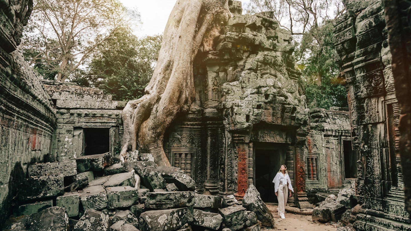 Traveler Exploring Ancient Ruins of Ta Prohm Temple at Angkor
1469688108