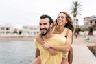 the woman is climbing on the man's back as she hugs him and they are both laughing. they are on the beach pier.
Preselect summer friends
1498188341