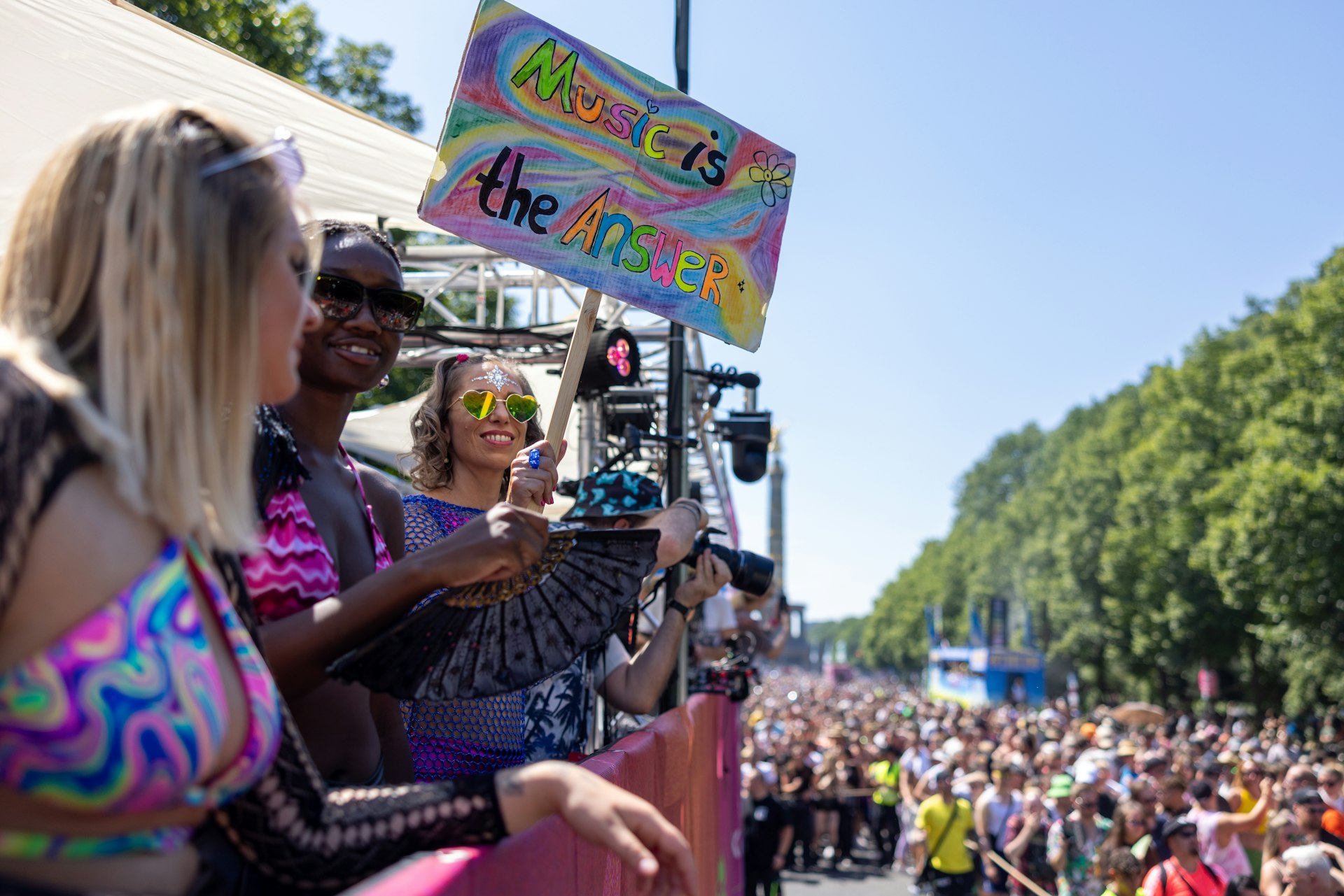  music enthusiasts dance during the Rave the Planet parade in Tiergarten park, Berlin, Germany