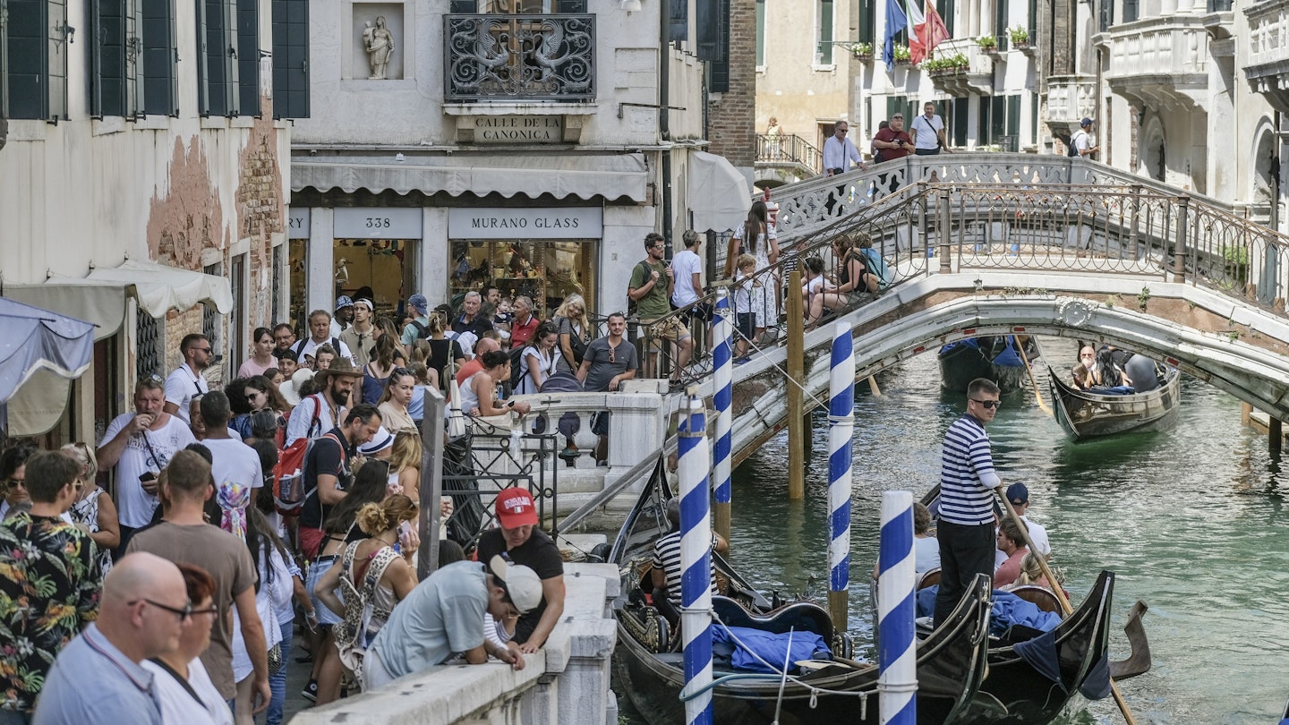 VENICE, ITALY - AUGUST 02: Tourists are crowded near a canal near St. Mark's Square on August 02, 2023 in Venice, Italy. UNESCO officials have included Venice and its lagoon to the list of world heritage in danger to review, along with Ukraine's Kyiv, and Lviv. The UN cultural agency deems Italy not effective in protecting Venice from mass tourism and extreme weather conditions. (Photo by Stefano Mazzola/Getty Images)
1587859000