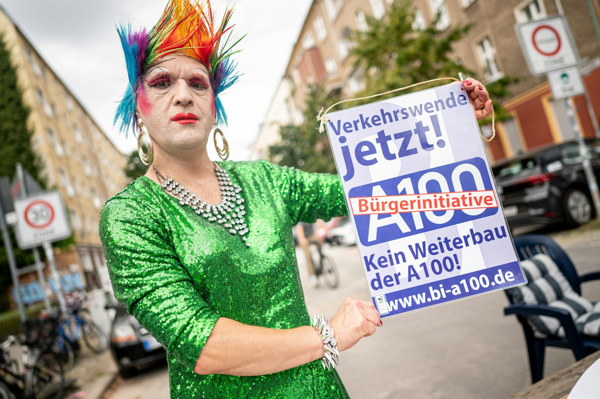 A protestor against the planned expansion of the A100 holds a poster with the inscription "Verkehrswende jetzt! No further construction of the A100!," Berlin, Germany