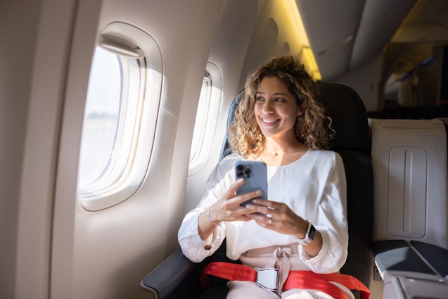Latin American female traveler using her cell phone in an airplane and looking through the window
1691534153
entertainment
Female traveler using her cell phone in an airplane - stock photo
Latin American female traveler using her cell phone in an airplane and looking through the window