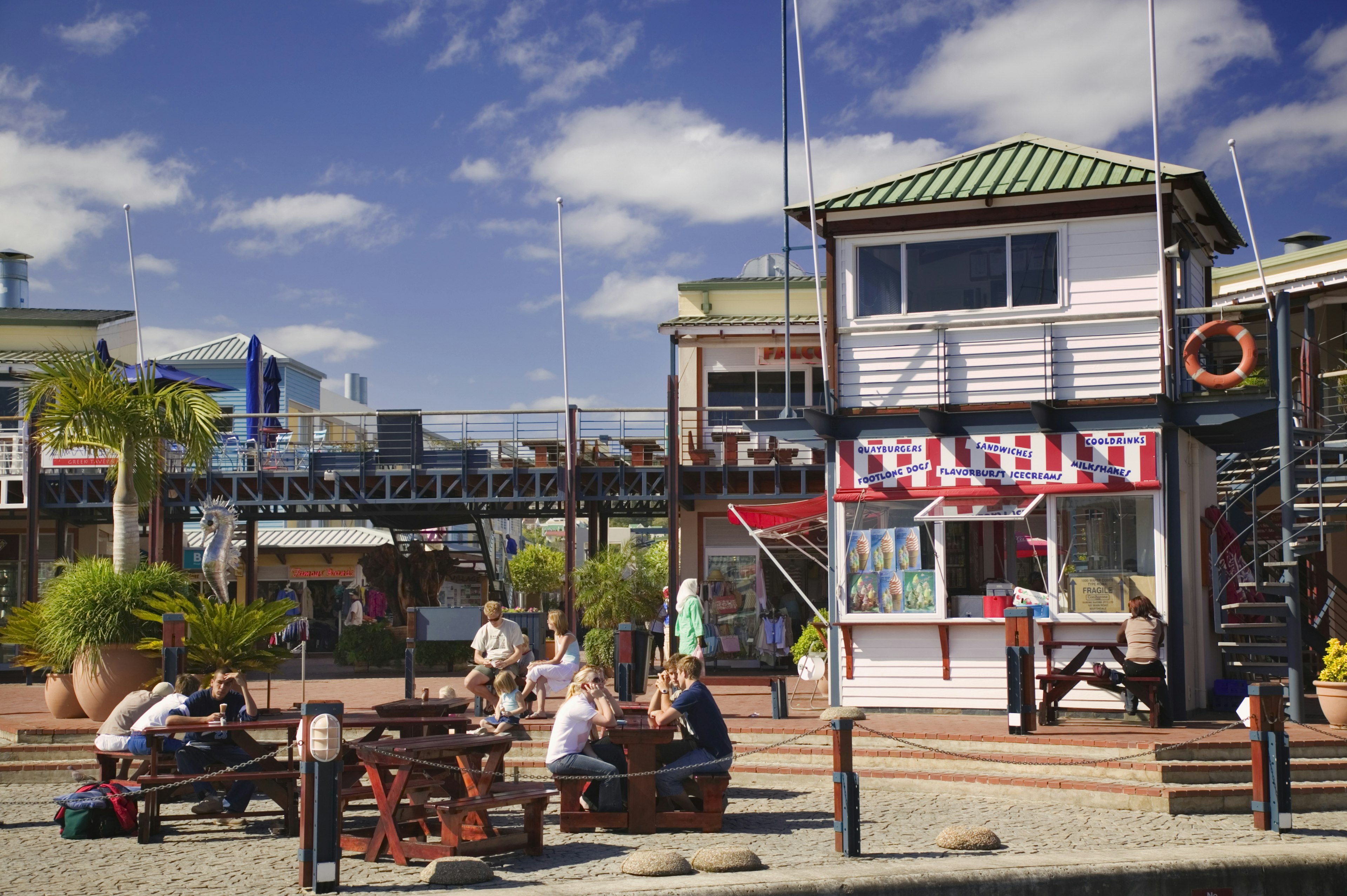 A group of people socialising and eating on the waterfront pier of Knysna