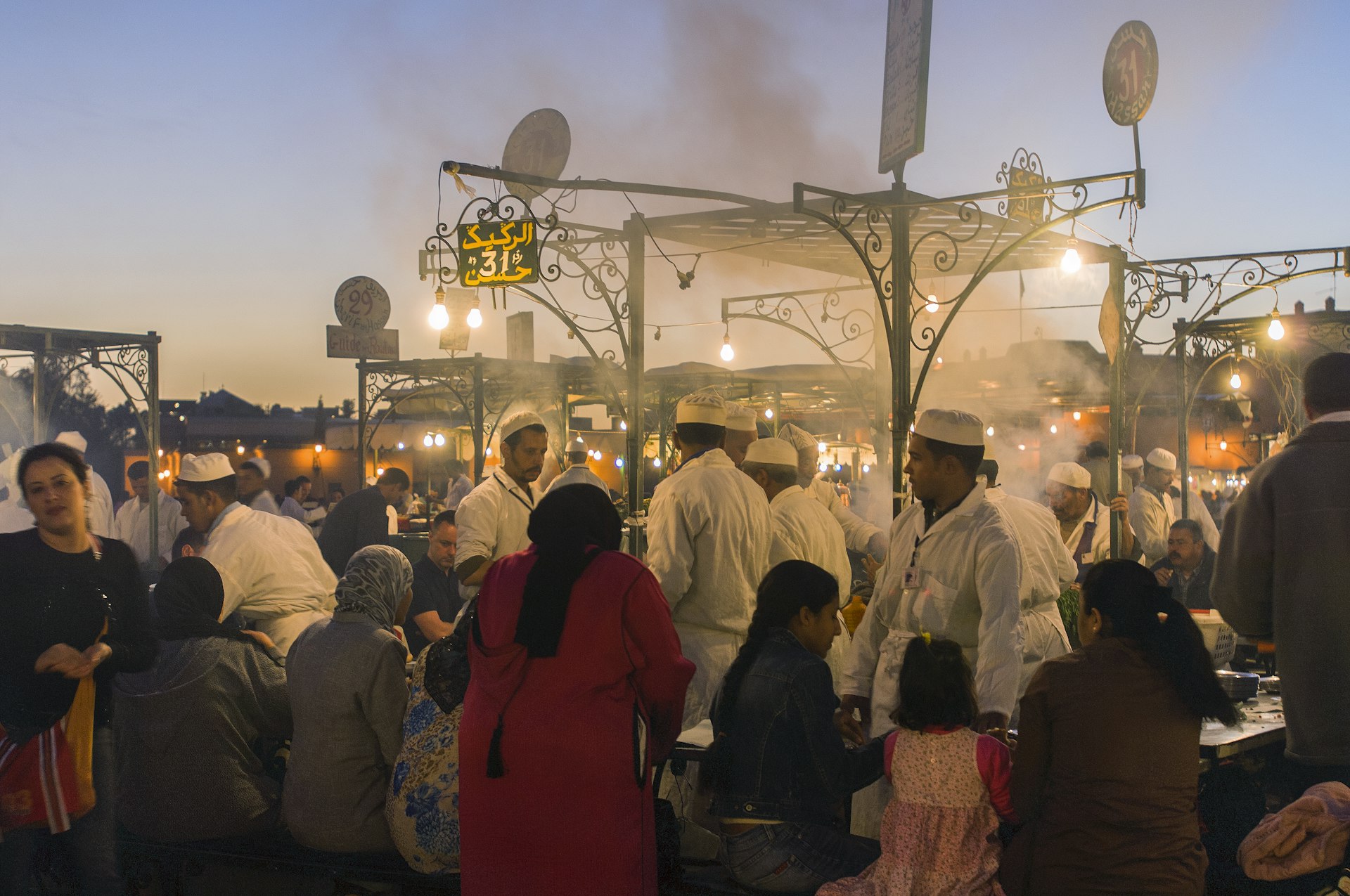 People eating in Djemaa El Fna square in Marrakesh, Morocco